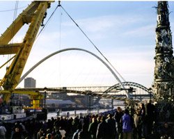 Crowds watch the arrival of the Gateshead Millennium Bridge