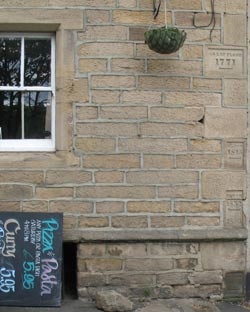 The wall of the Boat House at Newburn shows (at right) the height of River Tyne floodwaters over the years